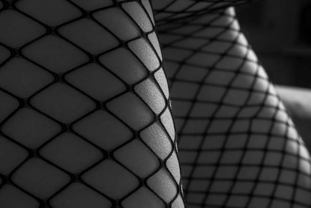 Close-up female legs in stockings, sexy pose, selective focus - Zdjęcie, obraz