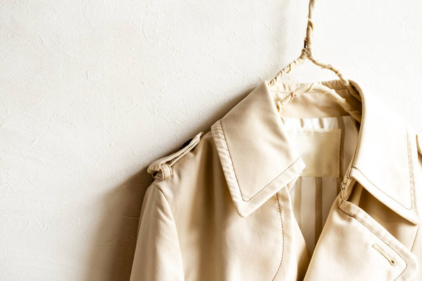 A beige trench coat isolated over white and close up. - Foto, imagen