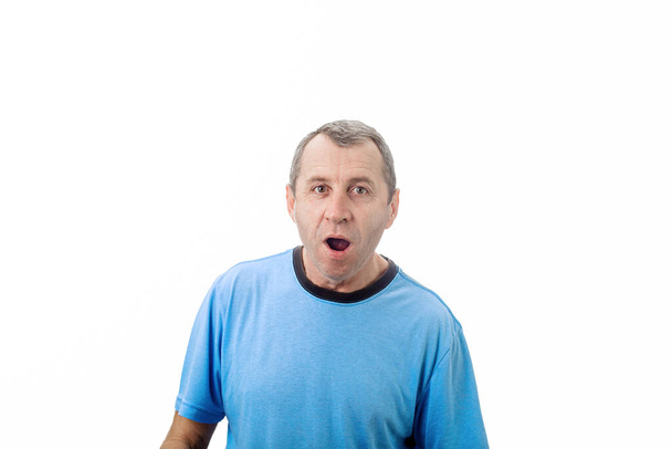 Shocked middle aged man with wide opened eyes and mouth isolated on white background with copy space. Surprised business middle aged worker with en astonished expression. - Photo, Image