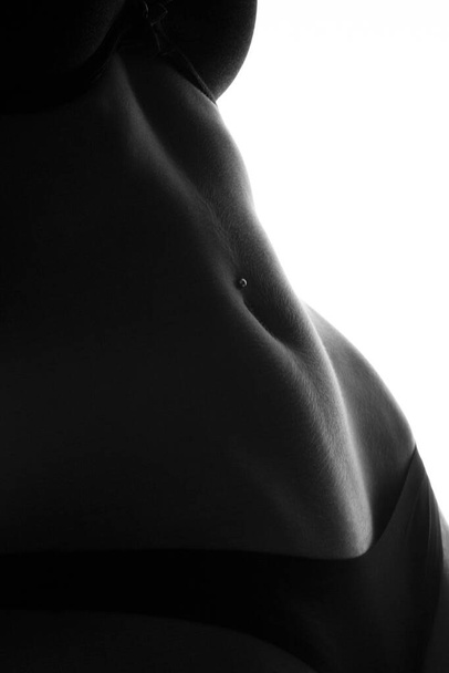 Crop photo of perfect female belly with piercing - Фото, зображення