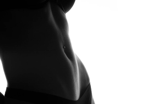 Crop photo of perfect female belly with piercing - Photo, Image