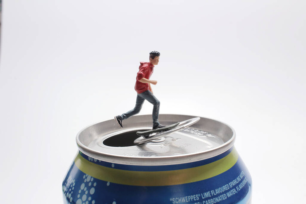 the mini figure play the Skateboard on can - Photo, Image