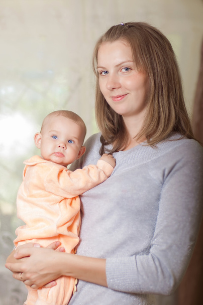 Young mother holding a baby - Foto, Bild