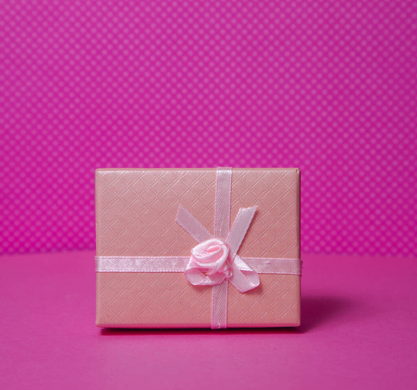 small present box on pink background - Foto, imagen