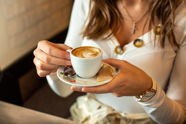 Gorgeous young woman drinking coffee alone in the restaurant - Foto, Imagem