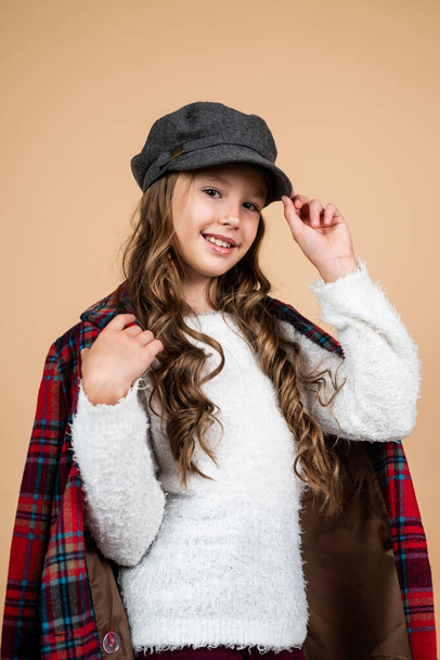 happy kid in cap with stylish hairstyle wear checkered jacket, casual - Zdjęcie, obraz