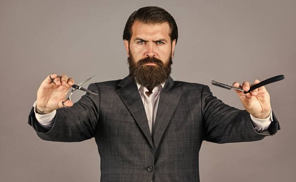Confident and handsome brutal man. facial care. Mature hipster with beard. brutal caucasian hipster with moustache. Male barber care. Bearded man hold hair retro razor blade - Foto, Imagem