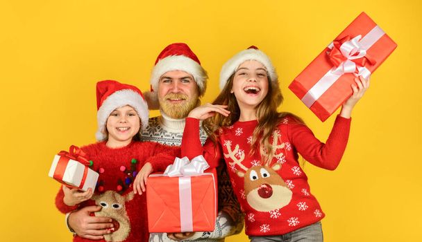 Presents for everybody. Christmas becomes special with children. Christmas eve concept. Family shopping. Christmas sale. Dad kids having fun. Father and little daughters celebrate new year together - Фото, зображення