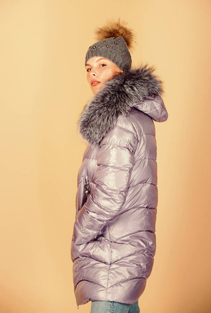 Fashion girl winter clothes. Fashion coat and hat. Fashion trend. Warming up. Casual winter jacket slightly more stylish and have more comfort features such as larger hood fur trim on hood. Faux fur - Foto, Bild