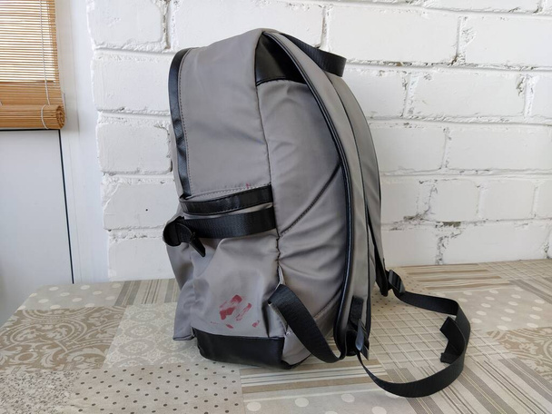 Gray backpack is on the table, isolated - Photo, Image