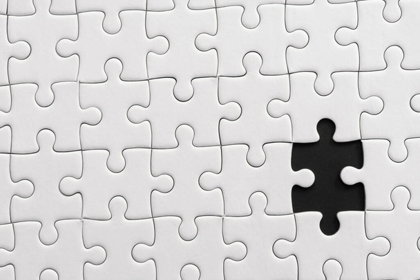 White jigsaw puzzle pattern background. placing last piece of jigsaw puzzl - Foto, imagen