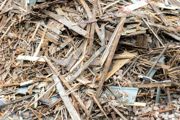 Closeup view of a large pile of rubble and debris from a demolished building. The pile consists of wood, brick, plaster, etc.  - Photo, Image