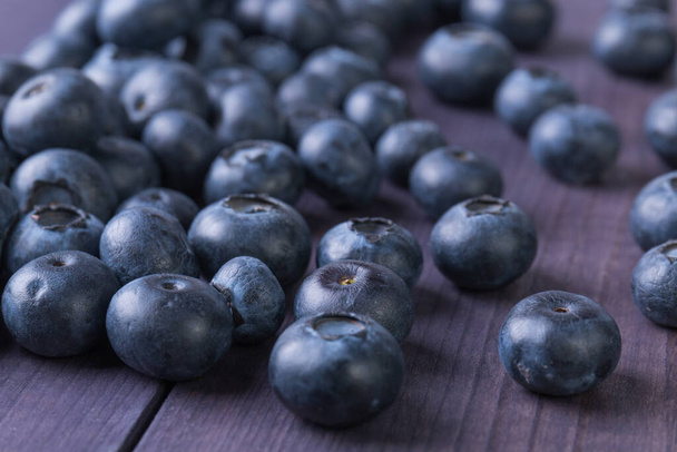 Fresh blueberry on rustic wooden table. Ripe berry background. Healthy food concept. Angle view - Photo, Image