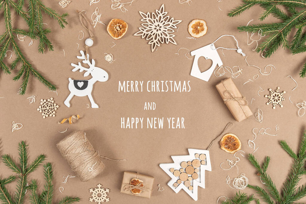 XMAS or New Year postcard. Frame, border made from boxes, twine, wood decoration, dried oranges and spruce branches on craft beige background. Concept Zero waste Merry Christmas Copy space. - Фото, зображення
