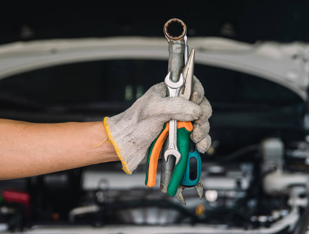 Hand of car mechanic with wrench auto mechanic Repair maintenance and car inspection - Φωτογραφία, εικόνα