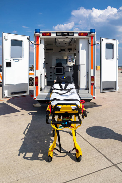 Emergency stretcher and EMS ambulance with open door - Foto, imagen