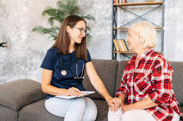 A doctor consulting senior female patient at home - Valokuva, kuva
