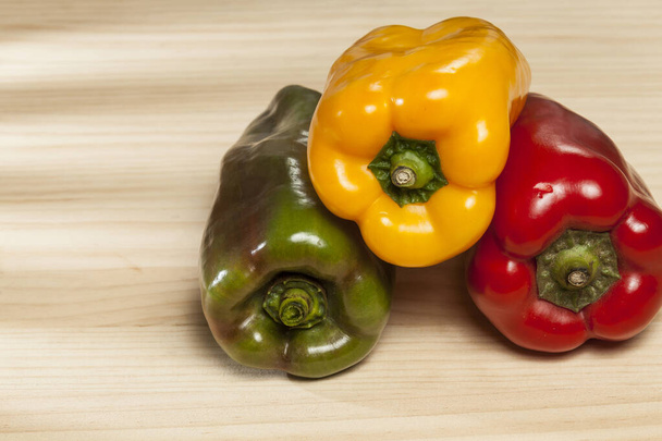 Capsicum annuum - Healthy food; three colored sweet peppers: red, yellow, and green. - Photo, Image
