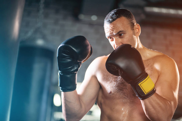 close up of muscular boxer male workout and training with punching bag in gym - Φωτογραφία, εικόνα