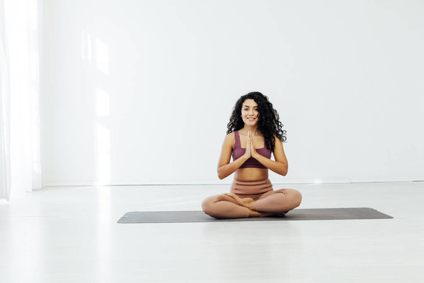 Beautiful brunette woman engaged in yoga fitness asana flexibility body - Photo, Image
