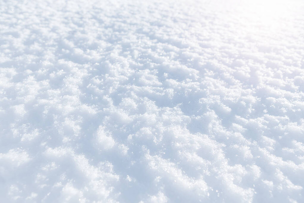 White snow winter texture. Christmas holiday background. Seasonal fresh white colour snow nature backdrop wallpaper. First frost. Crisp shiny textured ice frosty snow on sunny day outdoor. - Photo, Image