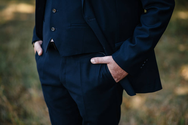 Hands of a man in the pockets of his trousers close-up - Photo, image
