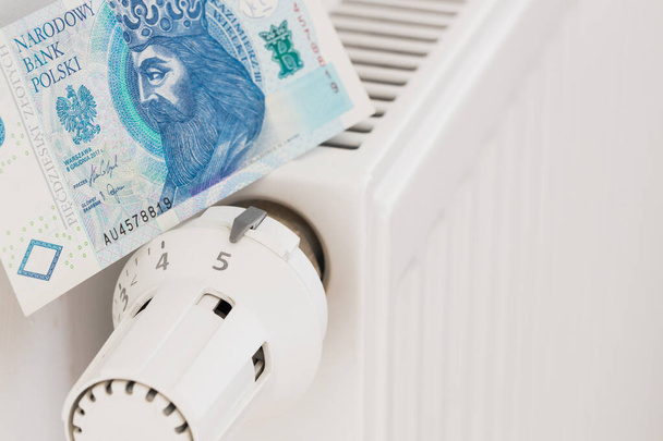 heating radiator and banknotes of 50 Polish zlotys. The concept of high costs of heating apartments - Photo, Image