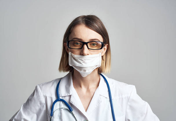 Professional nurse in a medical gown and mask on the face of an infection laboratory - Φωτογραφία, εικόνα