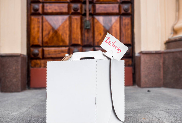 Contactless food delivery service concept. Paper bag with groceries ordered online delivered - Photo, image