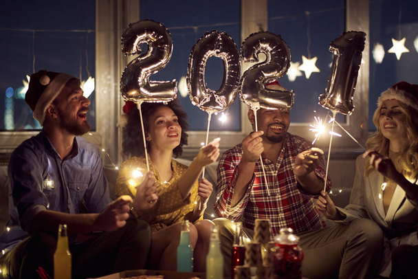 Cheerful couples making festive atmosphere at New Year eve home party. New Year, home party, friends time together - Foto, imagen