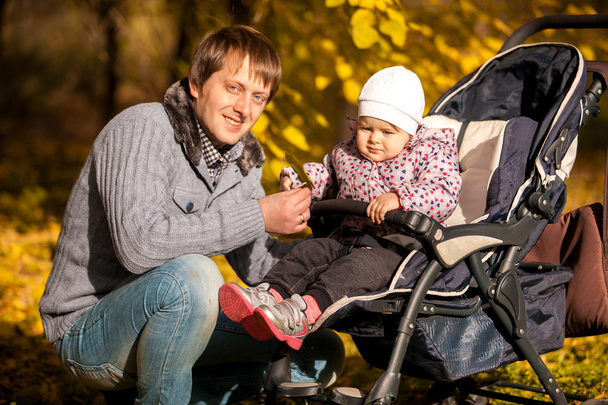 Ojciec i córka w buggy na jesień park - Zdjęcie, obraz