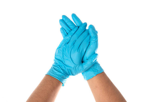 Doctors wear blue nitrile rubber gloves separately on a white background. - Photo, Image