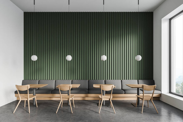 Interior of modern restaurant with white and green walls, concrete floor, square tables with chairs and gray sofa. 3d rendering - Foto, immagini