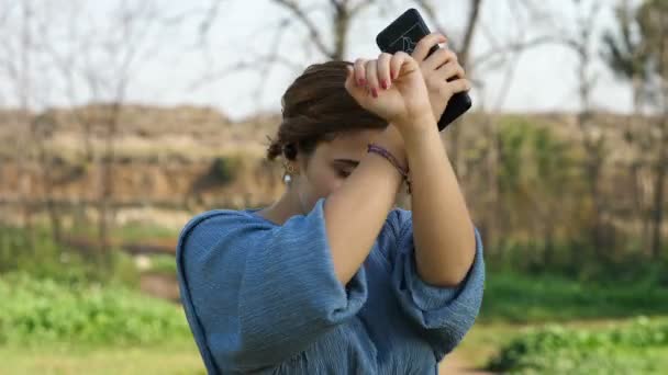 smartphone, technology - young woman listens to music on her mobile -slow motion - Filmmaterial, Video