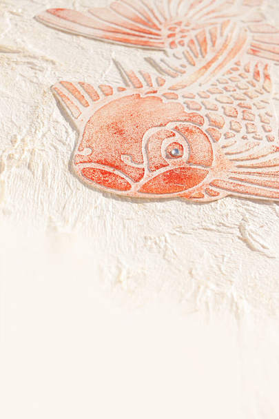 Canvas with fish engraved with relief paste made with stencil. Crumpled paper texture. Summer craft. - Foto, afbeelding