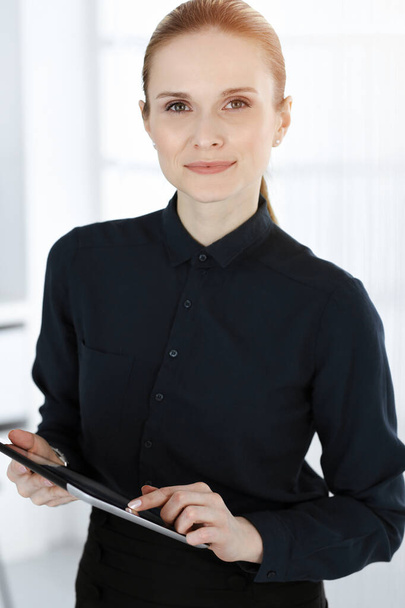 Business woman standing straight and looking at camera in white office. Business people concept - Fotoğraf, Görsel