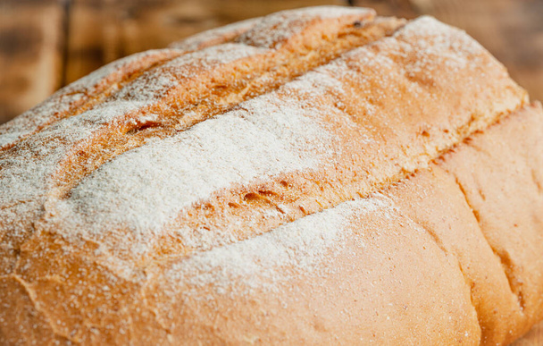 wheat bread on a wooden table - Zdjęcie, obraz