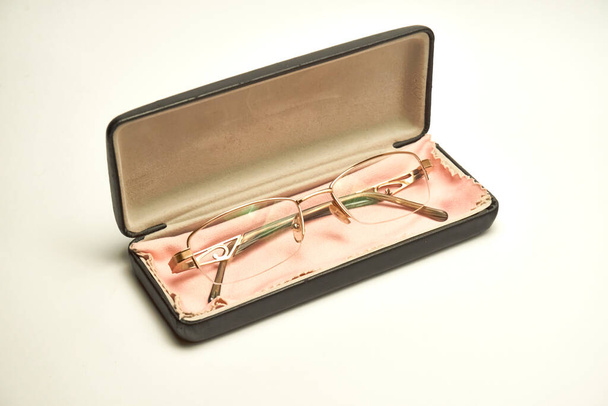 Bril in een koffer op een lichte ondergrond. - Foto, afbeelding