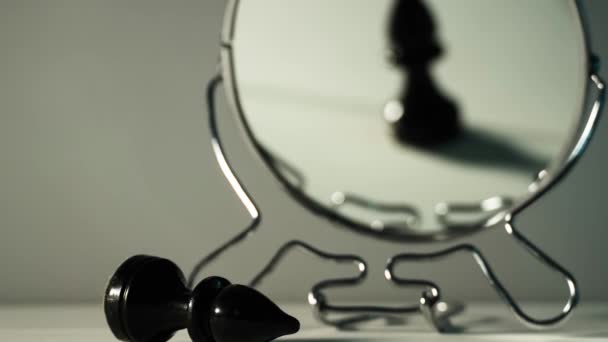 A chess piece is reflected in the mirror. Things and people are not what they seem. Reassessment of their abilities. Psychology, motivation. Power of thought. Never give up, always go for your goal. - Footage, Video