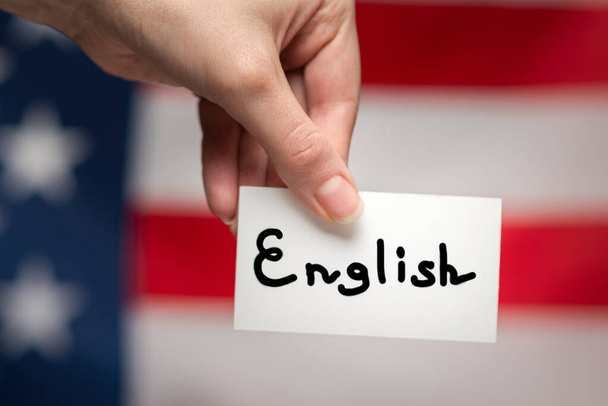 English text on a card. American flag background.  - Фото, изображение
