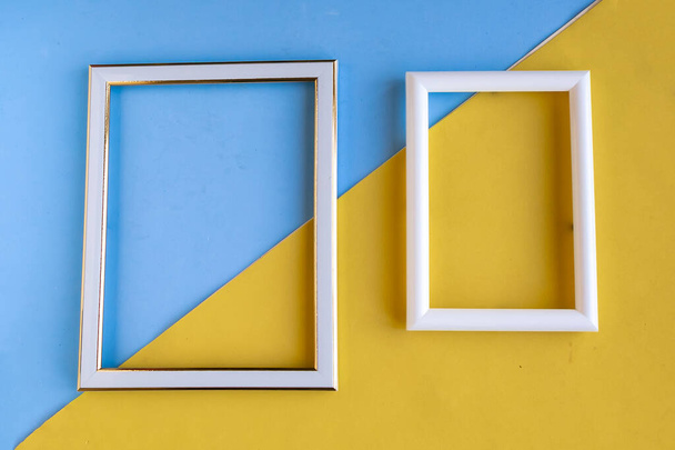 Two photo frames on color geometric background, copy space for the text - 写真・画像