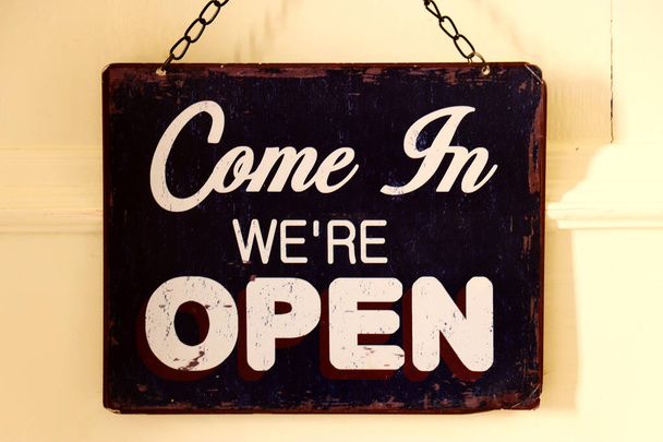 Open sign hanging on a wooden door - Come in we are open - Photo, Image