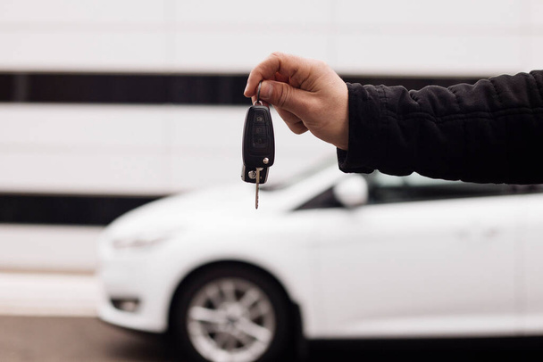 keys in hand on a background of white cars - Photo, Image