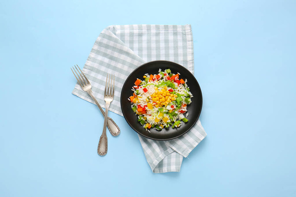 Plate of delicious rice salad with vegetables on color background - Photo, image