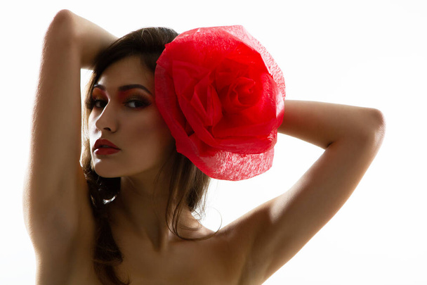 Vintage portrait of fashion glamour girl with red flower in her hair, over white. Studio shot. Spanish Carmen style - Φωτογραφία, εικόνα