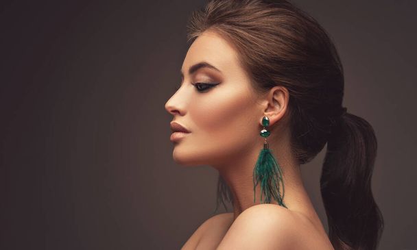 Beautiful girl with  tail and earrings - Photo, Image