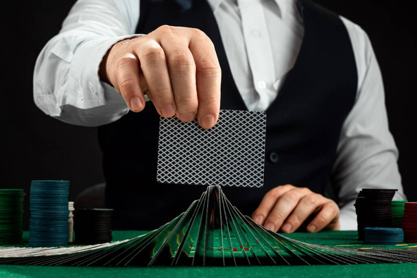 Male hands croupier shuffles cards close-up. Casino concept, gambling, blackjack - Photo, Image