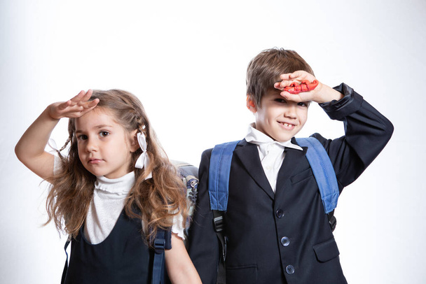 The boy and girl are now looking at the camera. They are wearing school uniforms.  - Fotoğraf, Görsel