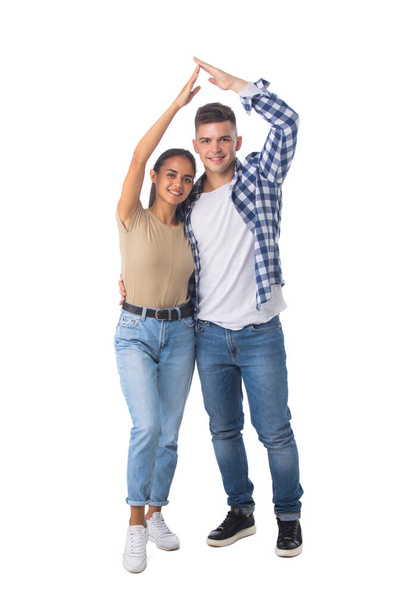 Young happy couple with roof house hand gesture isolated on white background, casual people - Foto, Imagem