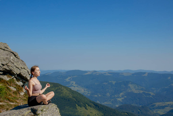 Yoga, Meditation. Woman balanced, practicing meditation and zen energy yoga in mountains. Woman doing fitness exercise sport outdoors in morning. Healthy lifestyle concept - Valokuva, kuva